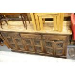 Continental hardwood and wrought iron sideboard of cupboard and drawers, L: 173 cm. This lot is