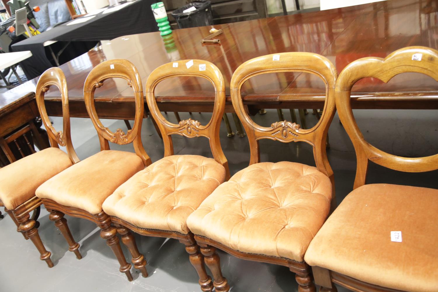 Two pairs of Victorian balloon back chairs with upholstered seats, and a further similar chair. This