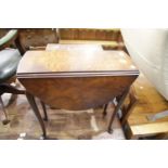 Small walnut drop leaf table with shaped top, H: 64 cm. This lot is not available for in-house P&P.