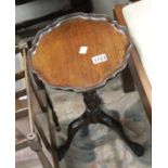 Antique mahogany wine table with scalloped edge top and tripod base, H: 48 cm. This lot is not