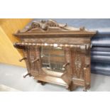 Heavily carved Victorian oak hallway coat rack with central mirror, W: 92 cm, H: 98 cm. This lot