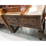 Antique oak heavily carved two drawer side table, 49 x 109 x 82 cm. This lot is not available for