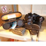 Two pairs of boots, leather cased binoculars and a vintage pair of opera glasses. This lot is not