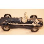 Cast iron Michelin Man in racing car, L: 25 cm. P&P Group 3 (£25+VAT for the first lot and £5+VAT