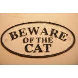 Cast iron Beware of The Cat sign, 17 x 9 cm. P&P Group 2 (£18+VAT for the first lot and £2+VAT for