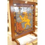 Glazed oak firescreen with woolwork crowned lion. This lot is not available for in-house P&P.