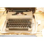 Cased Olympia typewriter. P&P Group 3 (£25+VAT for the first lot and £5+VAT for subsequent lots)