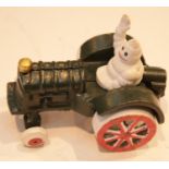 Cast iron Michelin Man in tractor, L: 11 cm. P&P Group 2 (£18+VAT for the first lot and £2+VAT for