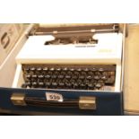 Cased Olivetti Dora typewriter. P&P Group 3 (£25+VAT for the first lot and £5+VAT for subsequent