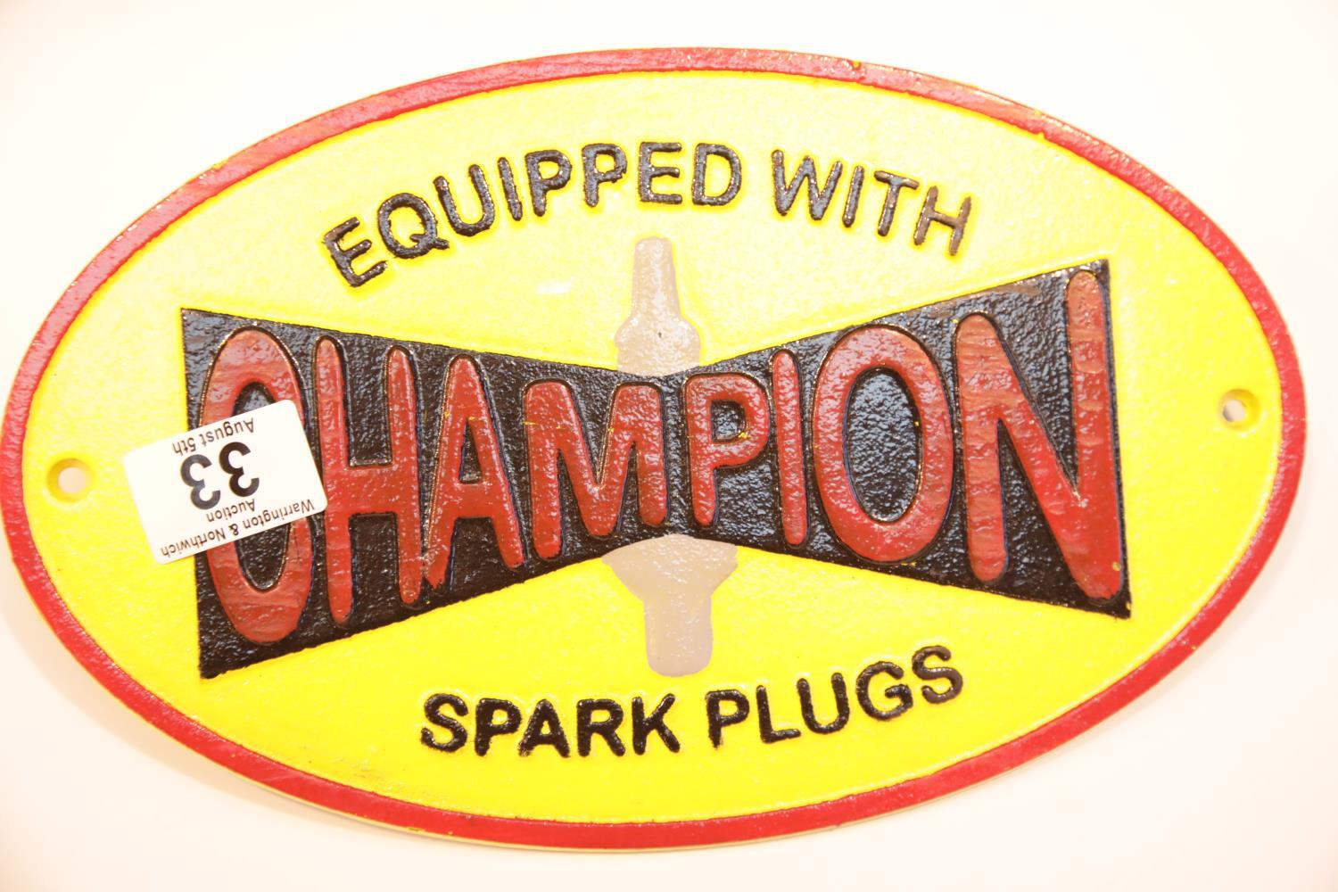 Cast iron Champion Spark Plugs sign, 28 x 17 cm. P&P Group 2 (£18+VAT for the first lot and £2+VAT