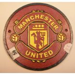 Cast iron circular Manchester United sign, D: 24 cm. P&P Group 2 (£18+VAT for the first lot and £2+