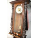 Large mahogany cased Ansonia type chiming wall clock with key and pendulum, L: 100 cm. This lot is