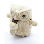 Vintage hand carved novelty tape measure in the form of an owl holding a rat. Possibly bone? P&P