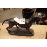 Cast iron dog with a bird in its mouth figurine, L: 24 cm. P&P Group 2 (£18+VAT for the first lot