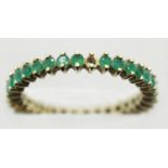 9ct gold emerald set eternity ring, size O/P, 1.9g. P&P Group 1 (£14+VAT for the first lot and £1+