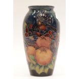 Medium sized blue ground Moorcroft vase in the Fruits of the Forest pattern, H: 20 cm. P&P Group