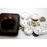 Various pocket watch movements and dials, and a leather goliath pocket watch case. P&P group 1 (£