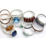 Ten silver stone set rings including blue topaz, emerald and tanzanite examples, and a gilt