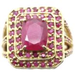 Impressive gilt washed silver dress ring set with a large central ruby surrounded by a multitude