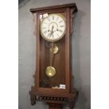 Chiming mahogany cased wall clock with key and pendulum. This lot is not available for in-house P&P.