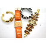 Joan Rivers Classics Collection, three ladies wristwatches (all requiring batteries) and a bangle