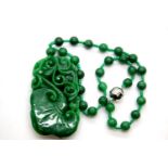 Carved jade pendant (9 x 5 cm) on a jade bead necklace. P&P group 1 (£14 for the first lot and £1