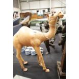 Large tan coloured leather camel with leather reigns, H: 71 cm. This lot is not available for in-