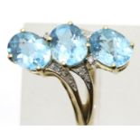 9ct gold blue topaz and diamond set dress ring, size P, 4.4g. P&P Group 1 (£14+VAT for the first lot