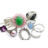Nine silver stone set rings including an articulated CZ example and a silver band, total weight 50g.