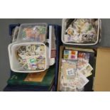 Quantity of loose stamps in tubs and boxes. This lot is not available for in-house P&P.