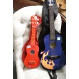 Two childrens instruments, First Act Discovery 3/4 guitar and Tiger ukulele, both with cases. This