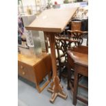 Ecclesiastical mahogany lectern with sloping bookstand, H: 137 cm. This lot is not available for