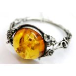 Sterling silver snap bangle set with a large Baltic amber type cabochon, 31g, D: 65 mm. P&P Group