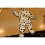 Cast iron Michelin man plaque, L: 33 cm. P&P Group 2 (£18+VAT for the first lot and £3+VAT for