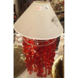 Unusual brass based table lamp with red discs. This lot is not available for in-house P&P.