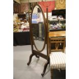 Edwardian inlaid mahogany cheval oval swing mirror with later additions. Not available for in-