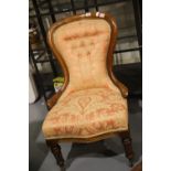Victorian walnut framed nursing chair, buttoned back, more recently upholstered. Not available for