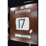 Large early 20th century perpetual wall calendar with brass knobs and canvas day, date and months,