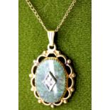 Yellow metal pendant with polished hardstone diamond set centre, L: 4.5 cm. P&P Group 1 (£14+VAT for