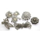 Four vintage white metal marcasite set brooches and a further white metal brooch. P&P Group 1 (£14+