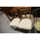 Pair of Victorian walnut framed salon chairs with more recently upholstered over-stuffed seats.