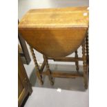 Small oak drop leaf table raised on bobbin supports. Not available for in-house P&P.