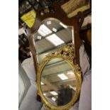 Regency inlaid mahogany framed shaped mirror, and a contemporary oval gilt framed mirror. Not