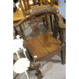 19th century heavily carved oak corner chair with pierced back rests, seat split. Not available