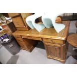 Modern pine twin pedestal desk, the tooled leather top above central drop front keyboard drawer