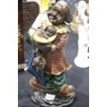 Contemporary bronze clown with dog figurine cold painted and plaster filled, H: 44 cm. This lot is