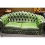 20thC Chesterfield style two-seater sofa, in green leather, L: 195 cm. This lot is not available for