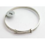 Silver heavy engraved childrens bangle. P&P Group 1 (£14+VAT for the first lot and £1+VAT for