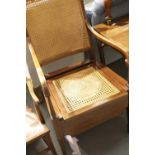 Early 20thC inlaid mahogany commode chair, having bergere woven seat and backrest. Ceramic pan