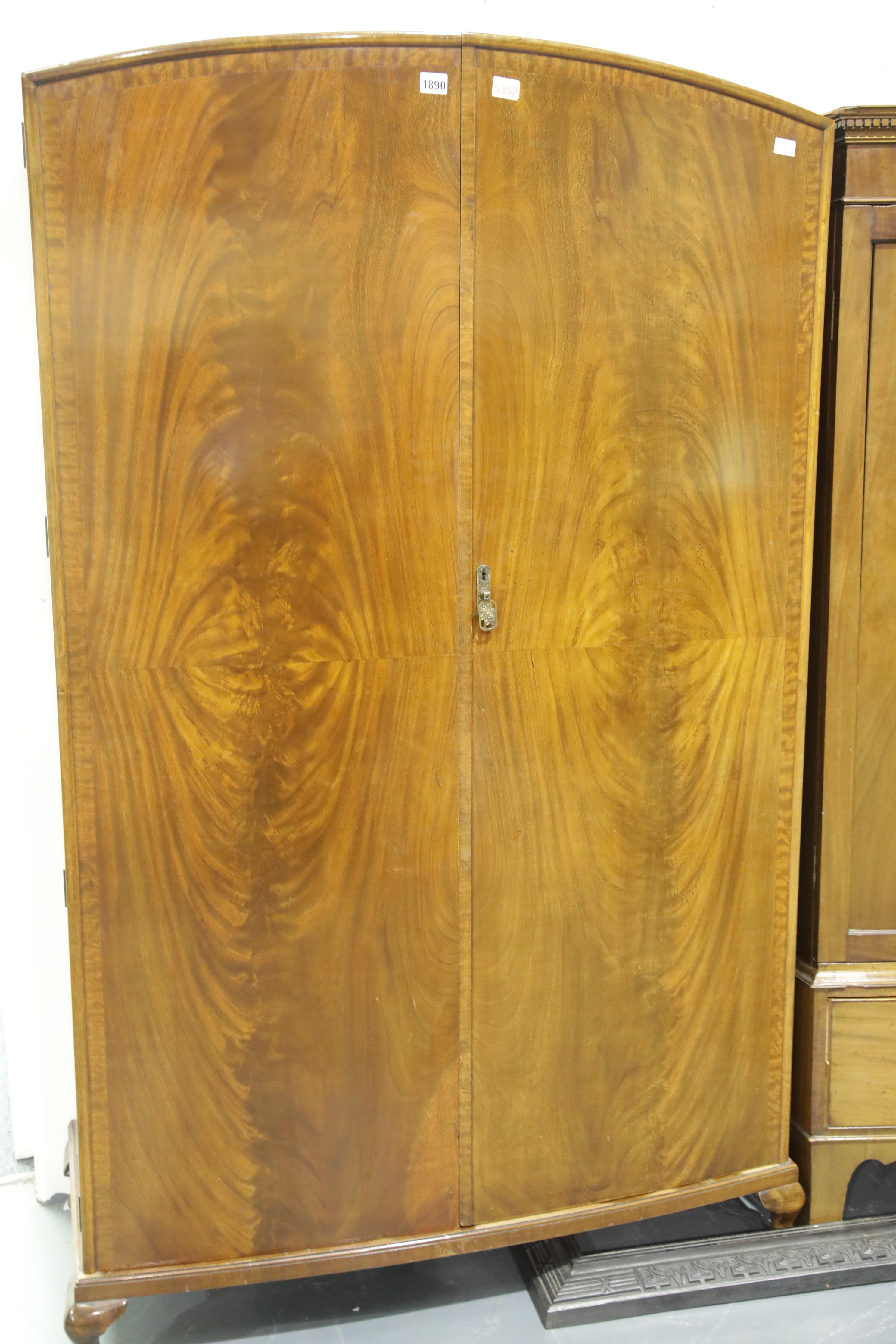 20th century mahogany two door wardrobe, having quartered veneer and cross banding. Not available